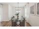 Well-lit dining room showcasing a glass table with modern chairs and stylish pendant lighting at 4754 Easter Ter, North Port, FL 34286