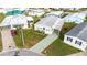 An aerial view shows the home with landscaping, well-maintained lawns, and a patterned driveway at 4946 Blanco Dr, Zephyrhills, FL 33541