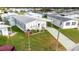 Aerial view of a home with a well-maintained yard, landscaping, and a paved driveway at 4946 Blanco Dr, Zephyrhills, FL 33541