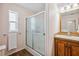 The bathroom features a shower stall with glass doors, and a vanity with a mirror above at 4946 Blanco Dr, Zephyrhills, FL 33541