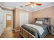 This bedroom features wood-look floors, a ceiling fan, and a closet with sliding doors at 4946 Blanco Dr, Zephyrhills, FL 33541