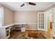 Bedroom featuring hardwood floors, a built-in desk with a window, and access to the bathroom at 4946 Blanco Dr, Zephyrhills, FL 33541
