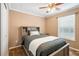This bedroom features wood-look floors, a ceiling fan, and a window with blinds at 4946 Blanco Dr, Zephyrhills, FL 33541