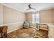 This bedroom features wood-look floors, a ceiling fan, and a window with curtains at 4946 Blanco Dr, Zephyrhills, FL 33541