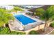 Community pool covered for the off season with seating and tropical landscaping at 4946 Blanco Dr, Zephyrhills, FL 33541