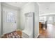Bright entryway with decorative door, coat rack and storage bench on hardwood floors at 4946 Blanco Dr, Zephyrhills, FL 33541