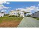 Well-kept home featuring lush landscaping, a driveway, and a covered carport at 4946 Blanco Dr, Zephyrhills, FL 33541