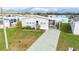 Charming home featuring well-maintained landscaping, a driveway, and a covered carport at 4946 Blanco Dr, Zephyrhills, FL 33541