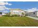 Well-maintained home with a landscaped front yard, a carport, and easy street access at 4946 Blanco Dr, Zephyrhills, FL 33541