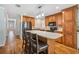 Well-equipped kitchen boasts wood cabinets, stainless steel refrigerator, and center island with bar seating at 4946 Blanco Dr, Zephyrhills, FL 33541