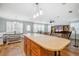 Open concept kitchen featuring a large island, built-in dining, and wood laminate floors at 4946 Blanco Dr, Zephyrhills, FL 33541