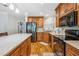 A kitchen features granite countertops, wood cabinets, and stainless steel appliances at 4946 Blanco Dr, Zephyrhills, FL 33541