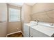 Functional laundry room featuring a washer, dryer, and a window for natural light at 4946 Blanco Dr, Zephyrhills, FL 33541