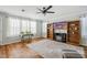 Cozy living room with hardwood floors, built-in shelving, and abundant natural light at 4946 Blanco Dr, Zephyrhills, FL 33541