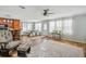 Spacious living and dining area featuring a ceiling fan and multiple windows for natural light at 4946 Blanco Dr, Zephyrhills, FL 33541