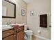 Bathroom with a granite vanity top, dark wood cabinet, and decorative mirror at 6216 Anhinga Pl, Tampa, FL 33615