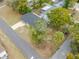 This is an aerial view of a home showcasing its roof, driveway, landscaping, and proximity to neighboring residences at 6232 Jackson St, New Port Richey, FL 34653
