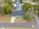 A birdseye view of a charming blue house showing the roof, driveway and some surrounding foliage at 6232 Jackson St, New Port Richey, FL 34653
