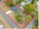 Aerial perspective of home featuring mature trees, grass, and lovely neighborhood at 6232 Jackson St, New Port Richey, FL 34653