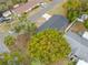 An aerial view of a home with a newly installed roof, a long driveway, and mature trees on a corner lot at 6232 Jackson St, New Port Richey, FL 34653
