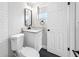Modern bathroom featuring a white vanity, black fixtures, and tiled flooring at 6232 Jackson St, New Port Richey, FL 34653