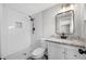 Updated bathroom featuring a tiled walk-in shower, granite vanity top, and modern fixtures at 6232 Jackson St, New Port Richey, FL 34653