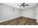 Bedroom featuring a ceiling fan, window, and hardwood floors at 6232 Jackson St, New Port Richey, FL 34653