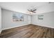 Bright bedroom features wood-look flooring and a window providing natural light at 6232 Jackson St, New Port Richey, FL 34653