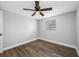 A cozy bedroom features wood floors, a ceiling fan, and a bright window at 6232 Jackson St, New Port Richey, FL 34653