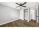 Bedroom with ceiling fan, hardwood flooring, and a closet at 6232 Jackson St, New Port Richey, FL 34653