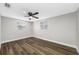 An open bedroom with a ceiling fan and two windows for ample natural light at 6232 Jackson St, New Port Richey, FL 34653