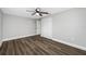 Light-filled bedroom features a ceiling fan, closet, and hardwood floors at 6232 Jackson St, New Port Richey, FL 34653