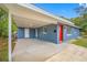 Exterior view of the carport attached to the home with a vibrant red front door at 6232 Jackson St, New Port Richey, FL 34653