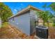 Side view of property exterior with newly painted wall and landscaping at 6232 Jackson St, New Port Richey, FL 34653