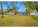 Lush green front and side yard with well-maintained lawn and foliage at 6232 Jackson St, New Port Richey, FL 34653