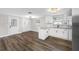 Open-concept kitchen features white cabinets and stainless steel appliances with a dining area at 6232 Jackson St, New Port Richey, FL 34653