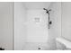 Bright and airy shower with white subway tile, mosaic floor, and black shower fixtures at 6232 Jackson St, New Port Richey, FL 34653
