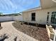 Landscaped backyard with a brick walkway and white fence at 6753 Thorman Rd, Port Charlotte, FL 33981