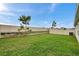 Well-maintained backyard with a privacy fence, manicured lawn, and mature landscaping at 7608 Broad Pointe Dr, Zephyrhills, FL 33540