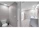 Spacious bathroom featuring a toilet, shower, and vanity with sink at 7608 Broad Pointe Dr, Zephyrhills, FL 33540