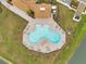 Overhead view of the community pool with lounge chairs and geometric pool design at 7608 Broad Pointe Dr, Zephyrhills, FL 33540