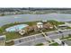 Aerial shot of a community pool with ample parking and stunning lake views in a new residential neighborhood at 7608 Broad Pointe Dr, Zephyrhills, FL 33540