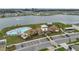Aerial view of the community pool, clubhouse, and lake in a residential neighborhood on a sunny day at 7608 Broad Pointe Dr, Zephyrhills, FL 33540