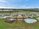 Aerial view of the community pool, playground, and covered outdoor space in a residential neighborhood at 7608 Broad Pointe Dr, Zephyrhills, FL 33540