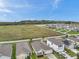 Aerial view of a single-Gathering home with a manicured lawn and a view of a fenced backyard at 7608 Broad Pointe Dr, Zephyrhills, FL 33540