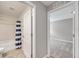 View of the hall with a bathroom on the left and bedroom on the right with modern neutral colors at 7608 Broad Pointe Dr, Zephyrhills, FL 33540