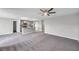 Open concept living room and kitchen, featuring modern lighting and stainless steel appliances at 7608 Broad Pointe Dr, Zephyrhills, FL 33540