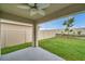 Covered patio with ceiling fan and a view of the fenced backyard and mature landscaping at 7608 Broad Pointe Dr, Zephyrhills, FL 33540