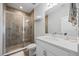 Modern bathroom features a glass-enclosed shower with brown tile and a sleek white vanity at 7782 93Rd N St, Seminole, FL 33777