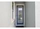 Stylish front door with glass pane, providing natural light and neighborhood views at 7782 93Rd N St, Seminole, FL 33777